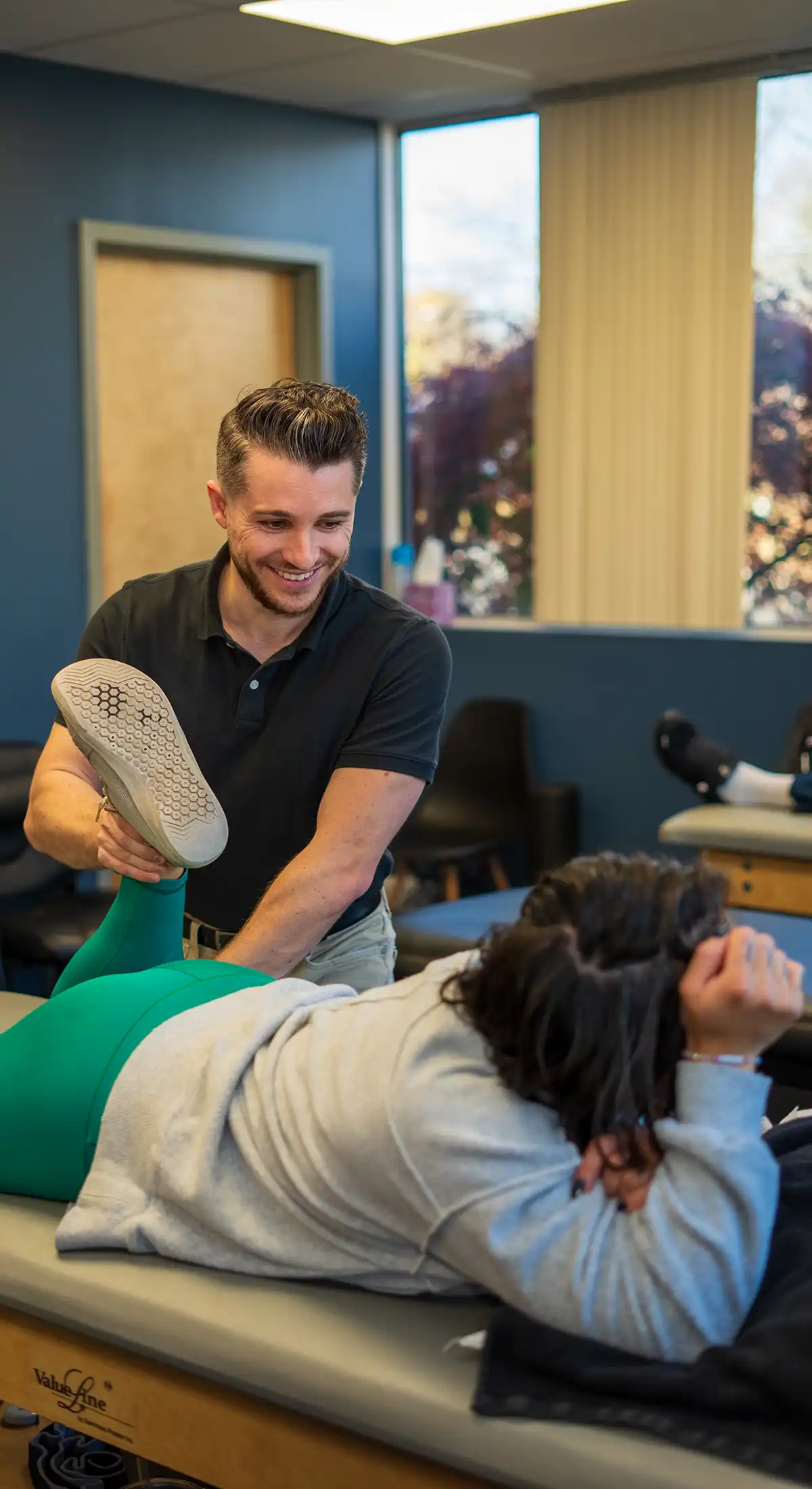 Physical therapist treating a patient's leg in our Springfield clinic